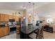 Open-concept kitchen features granite counters, stainless steel appliances, a center island, and seamless flow to the living area at 4211 73Rd E Ter, Sarasota, FL 34243