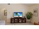 Inviting living room features a neutral color scheme and entertainment center, creating a cozy atmosphere at 4211 73Rd E Ter, Sarasota, FL 34243