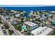 Aerial shot showcasing canal-front homes and surrounding streets near the blue condominium complex at 4307 Gulf Dr # 109, Holmes Beach, FL 34217