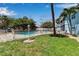 Well-maintained backyard, including a community pool, a manicured lawn, and a white fence at 4307 Gulf Dr # 109, Holmes Beach, FL 34217