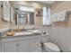 Charming bathroom with wainscoting, decor, and granite vanity at 4307 Gulf Dr # 109, Holmes Beach, FL 34217