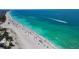 Picturesque beach scene with clear turquoise water, sunny skies, and boats cutting through the waves at 4307 Gulf Dr # 109, Holmes Beach, FL 34217