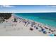 Expansive beachfront scene with people enjoying the sand, surf, and various beach activities at 4307 Gulf Dr # 109, Holmes Beach, FL 34217