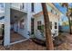 Lovely building exterior with a covered walkway, complemented by neat landscaping and mature trees at 4307 Gulf Dr # 109, Holmes Beach, FL 34217