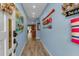 Hallway featuring light-blue paint and beach-themed decorations at 4307 Gulf Dr # 109, Holmes Beach, FL 34217