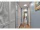 A hallway is lined with closet doors offering ample storage space, and views into the interior rooms at 4307 Gulf Dr # 109, Holmes Beach, FL 34217