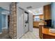 The kitchen features a stacked washer/dryer and is adjacent to wood cabinetry and tile floors for easy maintenance at 4307 Gulf Dr # 109, Holmes Beach, FL 34217