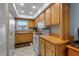 Kitchen featuring wooden cabinets, white appliances, and ceramic tile floors at 4307 Gulf Dr # 109, Holmes Beach, FL 34217