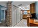 Spacious kitchen features wood cabinetry, white appliances, and a stacked washer and dryer concealed behind closet doors at 4307 Gulf Dr # 109, Holmes Beach, FL 34217