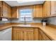 Kitchen featuring wooden cabinets, wooden countertop, white appliances, and window above the sink at 4307 Gulf Dr # 109, Holmes Beach, FL 34217