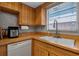 Spacious kitchen with wooden cabinets and countertops, stainless steel sink, and a window above at 4307 Gulf Dr # 109, Holmes Beach, FL 34217