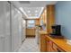 A tidy kitchen is showcased with bright lighting, tiled floors, and wood cabinets that provide ample storage space at 4307 Gulf Dr # 109, Holmes Beach, FL 34217