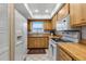 Efficient kitchen with wood cabinetry and white appliances, offering ample storage and cooking space at 4307 Gulf Dr # 109, Holmes Beach, FL 34217