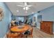 Cozy living room featuring bright blue walls, tile floors, dining table, and sliding glass door to a patio at 4307 Gulf Dr # 109, Holmes Beach, FL 34217