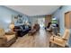 Comfortable living room with light blue walls, wood floors, fireplace, sliding glass door, and nautical wall decor at 4307 Gulf Dr # 109, Holmes Beach, FL 34217