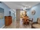Bright living room with light blue walls, wood floors, fireplace, and view of kitchen at 4307 Gulf Dr # 109, Holmes Beach, FL 34217