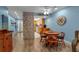 View of the living room, dining area, and kitchen, with a stone accent wall and light blue walls at 4307 Gulf Dr # 109, Holmes Beach, FL 34217