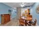 Cozy living room with view of the kitchen, dining table, and wood floors at 4307 Gulf Dr # 109, Holmes Beach, FL 34217