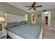 Comfortable main bedroom with large bed, ceiling fan, view to ensuite bathroom, and access to hallway at 4307 Gulf Dr # 109, Holmes Beach, FL 34217