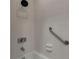 Bright tiled shower with accessible grab bar and shelving at 4307 Gulf Dr # 109, Holmes Beach, FL 34217