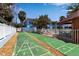 Community shuffleboard with views of a swimming pool, building, and cabana in a lush setting at 4307 Gulf Dr # 109, Holmes Beach, FL 34217