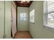 Bright sunroom with textured walls, curtain, and windows at 4307 Gulf Dr # 109, Holmes Beach, FL 34217