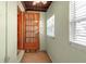 Sunroom with tiled floor, windows with blinds, and an exterior door at 4307 Gulf Dr # 109, Holmes Beach, FL 34217