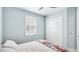 This bedroom features a neutral color palette, shuttered window, and a large closet with paneled doors at 4325 Renwick Dr, Parrish, FL 34219