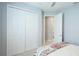 Cozy bedroom shows large closet and access door with neutral carpeting and soft, light walls at 4325 Renwick Dr, Parrish, FL 34219