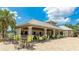 Outdoor clubhouse featuring covered seating areas, tables, chairs, and an outdoor kitchen perfect for entertaining at 4325 Renwick Dr, Parrish, FL 34219