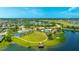 Aerial view of the community featuring a pool, splashpad, basketball court, playground, stage, and lakefront dock at 4325 Renwick Dr, Parrish, FL 34219