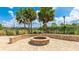 Outdoor brick fire pit with comfortable seating and manicured landscaping for cozy evenings at 4325 Renwick Dr, Parrish, FL 34219