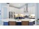 Bright kitchen features stainless steel appliances, stylish countertops, and a central island with seating at 4325 Renwick Dr, Parrish, FL 34219