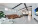 Open-concept living room boasts vaulted ceilings, beams, and seamless access to the modern kitchen at 4325 Renwick Dr, Parrish, FL 34219