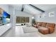 Inviting living room featuring a leather sectional, access to the pool, and natural light at 4325 Renwick Dr, Parrish, FL 34219