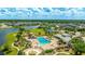 Aerial view of the neighborhood pool featuring a splashpad, playground, tennis court, and modern clubhouse for community enjoyment at 4325 Renwick Dr, Parrish, FL 34219