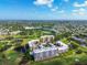 Aerial view of condo buildings surrounded by a golf course and trees at 4460 Fairways Blvd #604 Blvd # 604, Bradenton, FL 34209