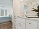 Bright bathroom boasts white cabinets, quartz countertops, and views into the bedroom at 4460 Fairways Blvd #604 Blvd # 604, Bradenton, FL 34209