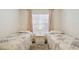 Bright bedroom featuring two twin beds, light colored walls and a window at 4460 Fairways Blvd #604 Blvd # 604, Bradenton, FL 34209