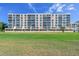Exterior view of multi-story condo building with manicured lawn at 4460 Fairways Blvd #604 Blvd # 604, Bradenton, FL 34209