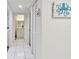 Bright hallway leading to bathroom, with a linen closet and an octopus wall decoration at 4460 Fairways Blvd #604 Blvd # 604, Bradenton, FL 34209