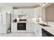 Clean, white kitchen with modern appliances, white subway tile backsplash and stainless steel sink at 4460 Fairways Blvd #604 Blvd # 604, Bradenton, FL 34209