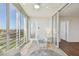 Light filled lanai with tiled floors, wicker furniture, and balcony access at 4460 Fairways Blvd #604 Blvd # 604, Bradenton, FL 34209