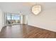 Bright living room with wood floors, modern chandelier, and balcony access at 4460 Fairways Blvd #604 Blvd # 604, Bradenton, FL 34209