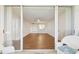 View from the balcony into the light and open living room with wood floors at 4460 Fairways Blvd #604 Blvd # 604, Bradenton, FL 34209