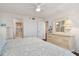 Bedroom featuring wood floors, dresser, and ensuite bathroom at 4460 Fairways Blvd #604 Blvd # 604, Bradenton, FL 34209