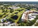 Community aerial view with golf course, ponds, and residential buildings at 4570 Pinebrook Cir # 406, Bradenton, FL 34209