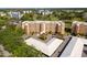 Aerial view of a condo building with lush green surroundings and a parking area at 4570 Pinebrook Cir # 406, Bradenton, FL 34209