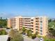 Aerial view of the multi-story condo building and community parking area at 4570 Pinebrook Cir # 406, Bradenton, FL 34209