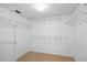 Spacious walk-in closet with white wire shelving and neutral carpeting at 4570 Pinebrook Cir # 406, Bradenton, FL 34209